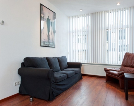 Living Room Sofa with Single Chair and Window Kerkstraat apartment Amsterdam