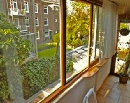View from back of house, enclosed balcony off the bedroom facing neighbour gardens