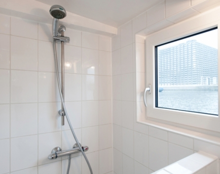 Shower, situated apart from the guest room, behind the kitchen